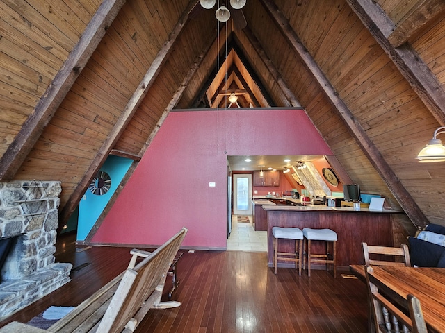 interior space featuring vaulted ceiling with beams, hardwood / wood-style floors, and wood ceiling