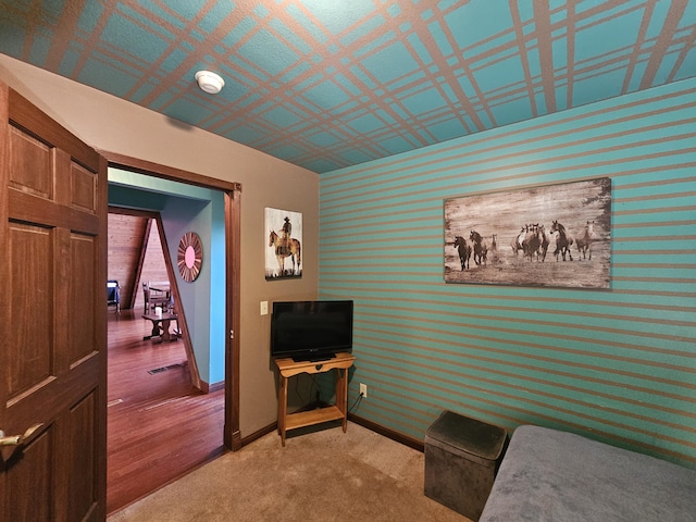 bedroom with wallpapered walls and baseboards