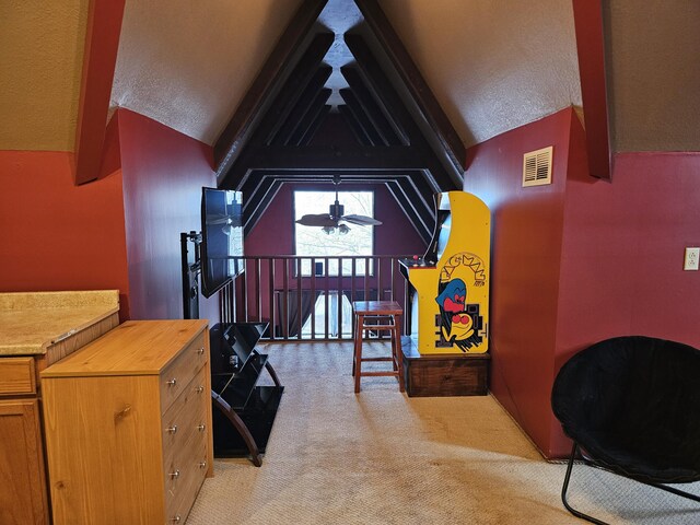 bonus room with light colored carpet, visible vents, ceiling fan, and lofted ceiling with beams