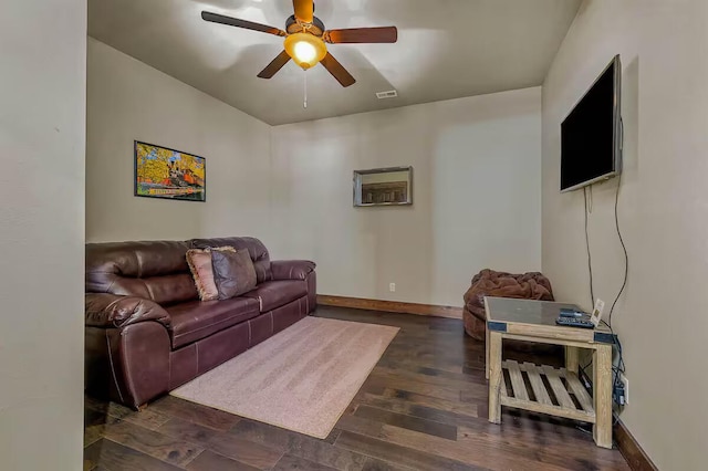 living room with ceiling fan, dark wood-style flooring, visible vents, and baseboards