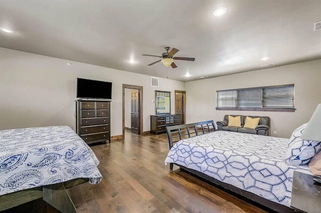 bedroom with baseboards, visible vents, wood finished floors, and recessed lighting