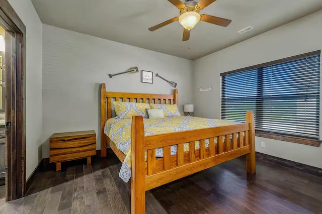 bedroom with baseboards, visible vents, ceiling fan, and wood finished floors