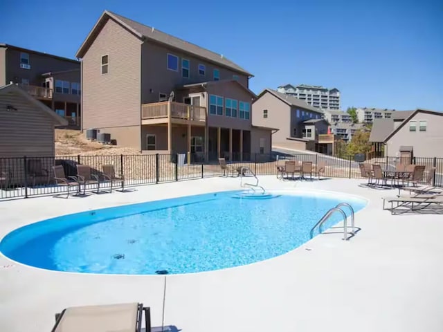 view of pool with fence and a patio