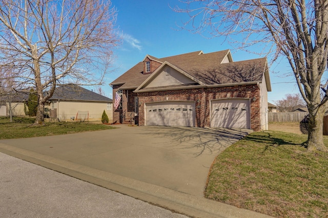 view of front facade with brick siding, an attached garage, fence, driveway, and a front lawn