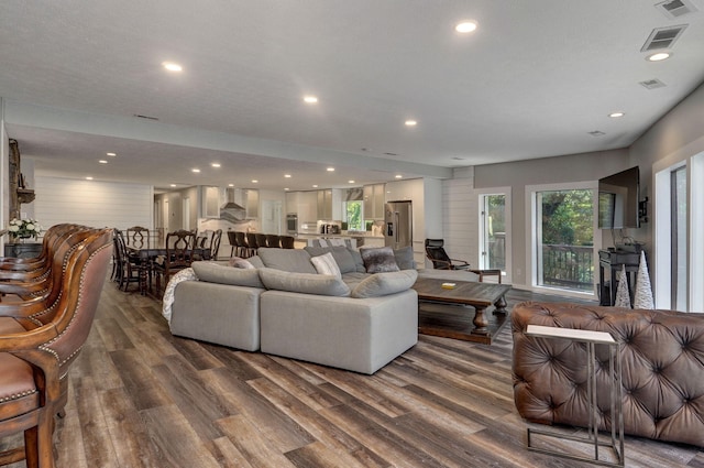 living room with recessed lighting, visible vents, plenty of natural light, and wood finished floors