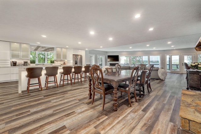 dining area featuring recessed lighting, a wealth of natural light, and wood finished floors