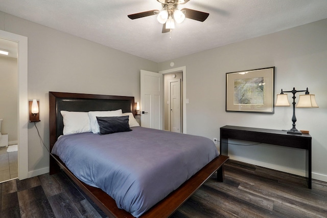 bedroom with ceiling fan, baseboards, and wood finished floors