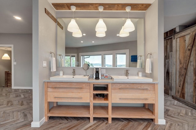 full bathroom with double vanity, a sink, and baseboards