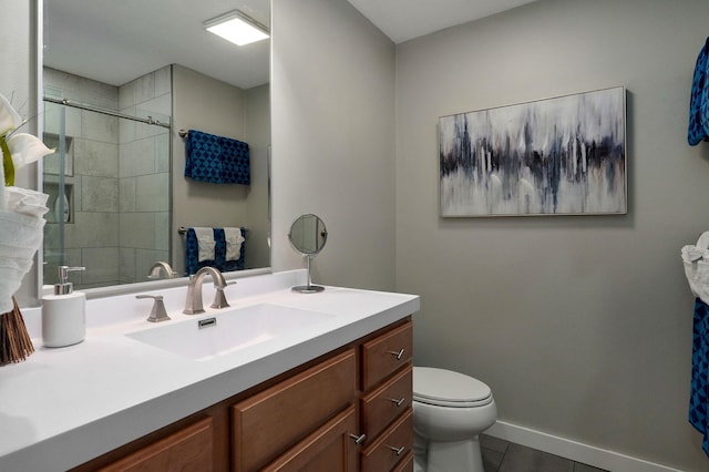 bathroom with baseboards, toilet, tile patterned flooring, vanity, and a shower stall