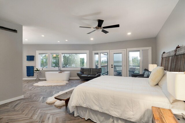 bedroom with baseboards, access to outside, a barn door, and recessed lighting