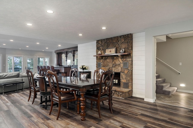 dining space featuring recessed lighting, stairway, a textured ceiling, wood finished floors, and baseboards