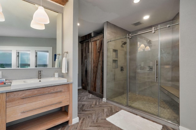 bathroom with a stall shower, vanity, visible vents, and recessed lighting