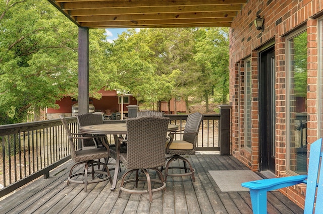 wooden terrace with outdoor dining space