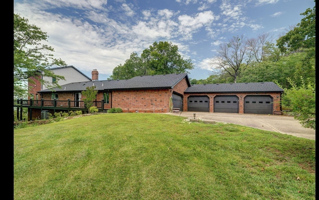 exterior space with a garage, brick siding, driveway, a chimney, and a front yard