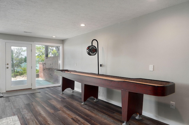 playroom featuring a textured ceiling, wood finished floors, and baseboards