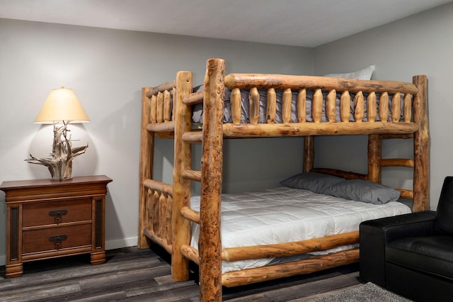 bedroom featuring dark wood-style flooring and baseboards