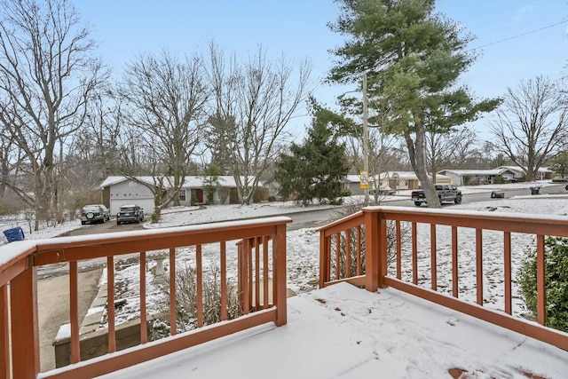 snow covered deck with a residential view