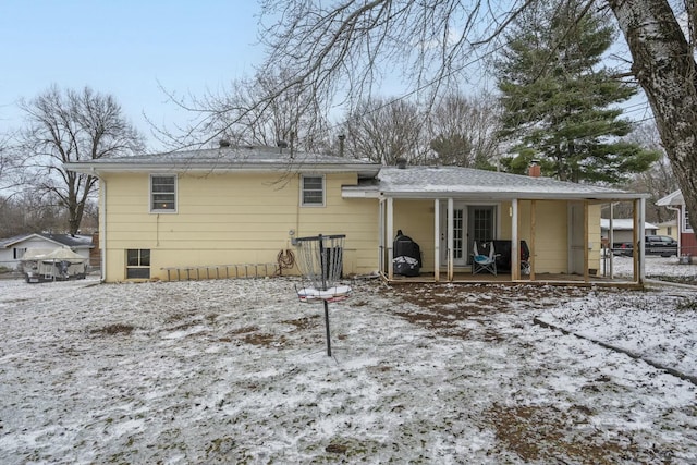 snow covered property featuring a chimney