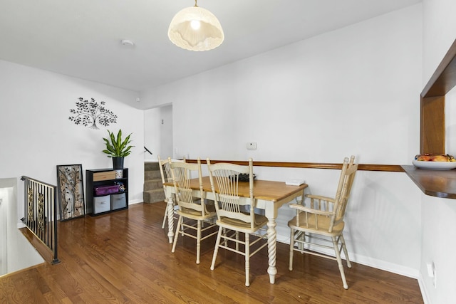 dining area with wood finished floors and baseboards