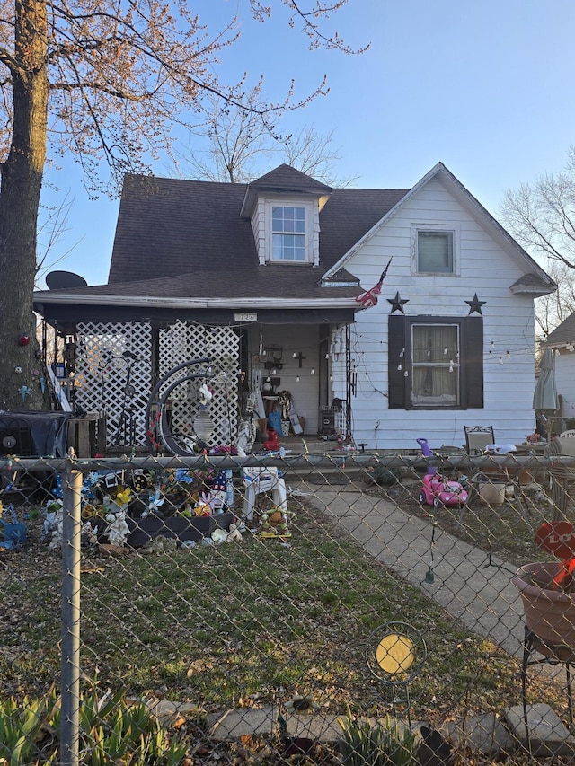 bungalow-style home with fence