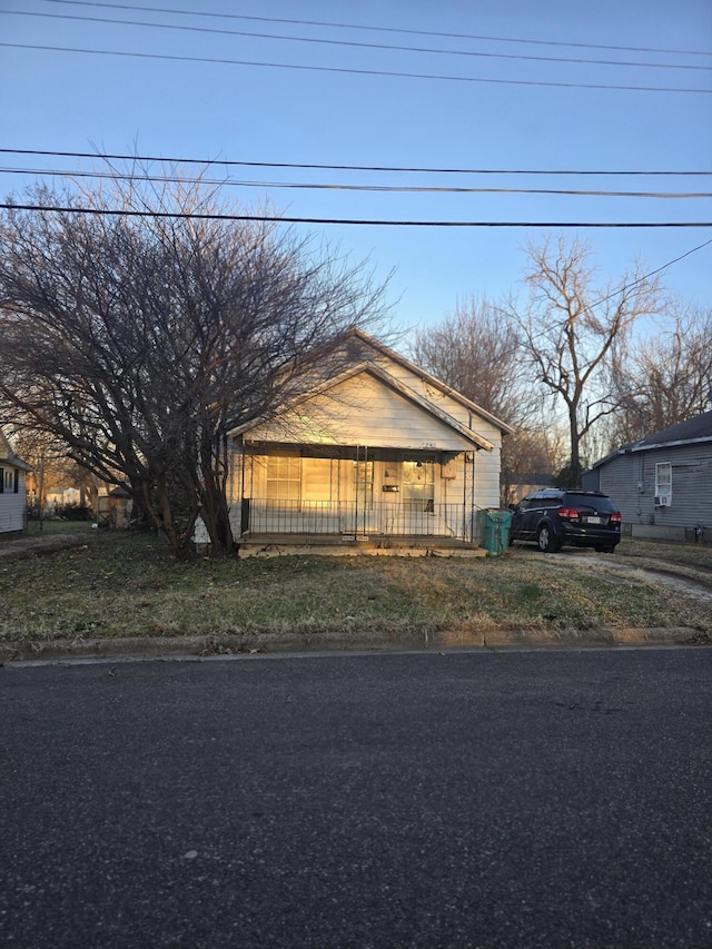 bungalow-style home with fence