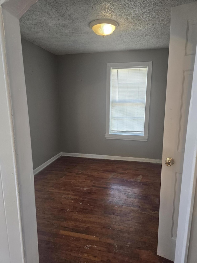 2140 N Roosevelt Ave, Springfield, MO 65803 - spare room with dark wood-type flooring and a textured ceiling