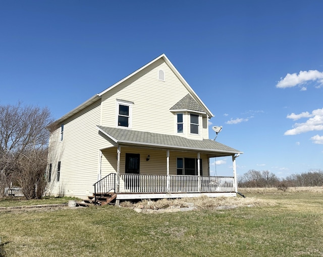 farmhouse with a porch and a front yard