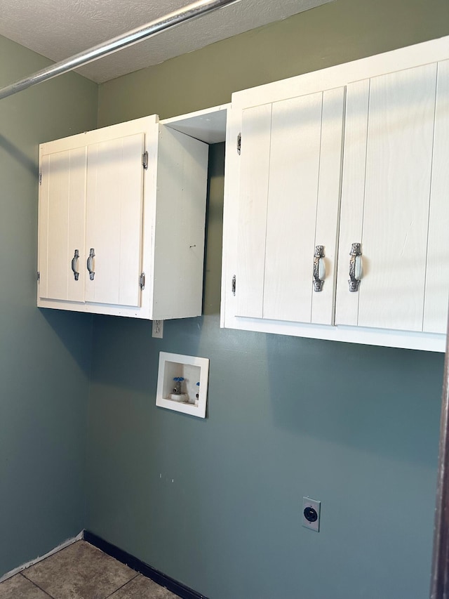 laundry room featuring washer hookup, cabinet space, electric dryer hookup, and a textured ceiling