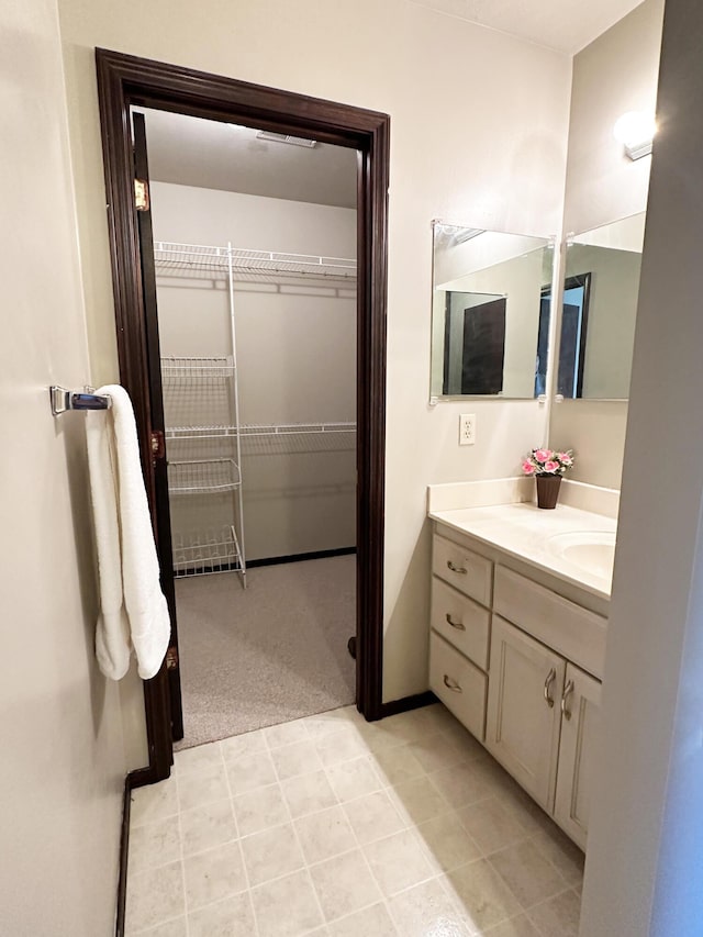 bathroom with vanity and a spacious closet