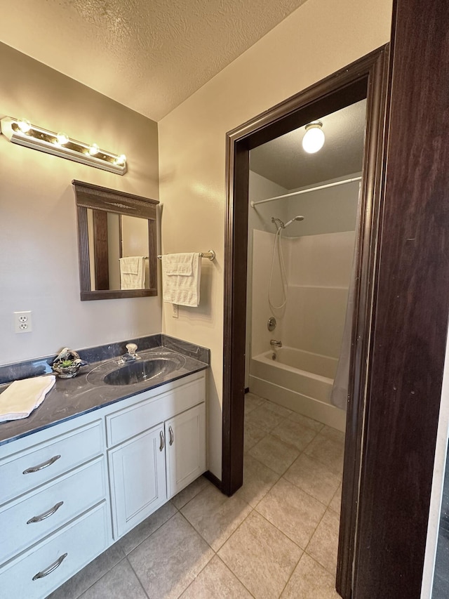 bathroom featuring  shower combination, tile patterned flooring, a textured ceiling, and vanity