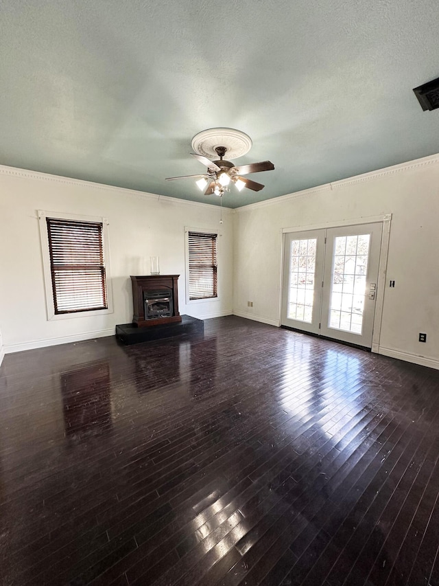 unfurnished living room with a ceiling fan, a glass covered fireplace, crown molding, and hardwood / wood-style flooring