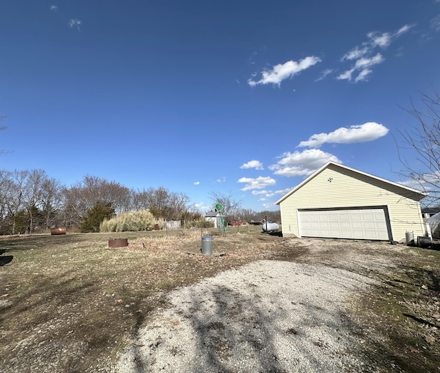 view of yard featuring an outbuilding and a detached garage