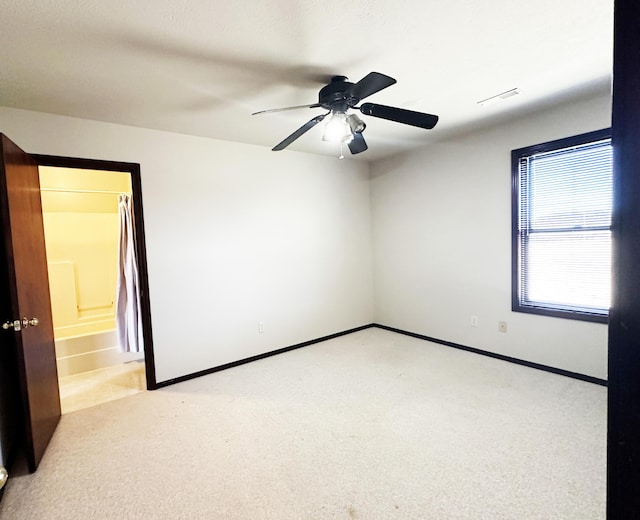 unfurnished room featuring light carpet, visible vents, and baseboards