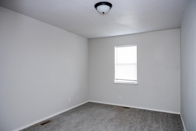 908 Jefferson Ave, Joplin, MO 64801 - carpeted spare room with baseboards, visible vents, and a textured ceiling