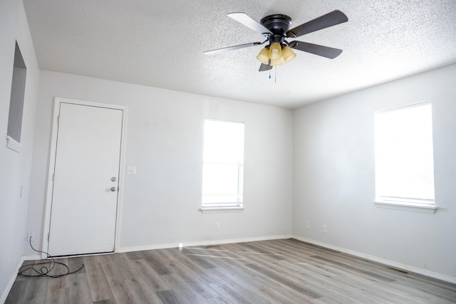 908 Jefferson Ave, Joplin, MO 64801 - empty room featuring a textured ceiling, ceiling fan, wood finished floors, visible vents, and baseboards