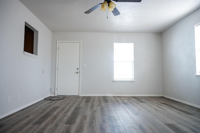 908 Jefferson Ave, Joplin, MO 64801 - spare room with a textured ceiling, wood finished floors, and baseboards
