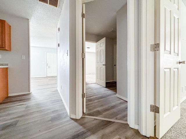 908 Jefferson Ave, Joplin, MO 64801 - hallway with light wood-style flooring, a textured ceiling, and baseboards