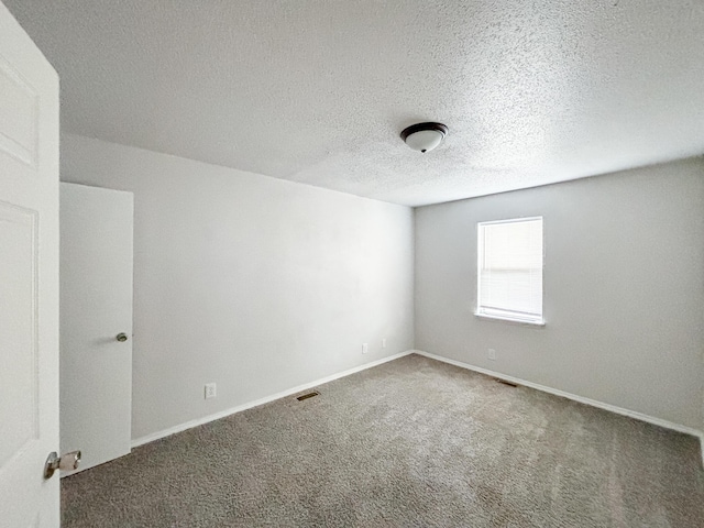 908 Jefferson Ave, Joplin, MO 64801 - carpeted spare room with a textured ceiling, visible vents, and baseboards