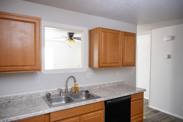 908 Jefferson Ave, Joplin, MO 64801 - kitchen with black dishwasher, dark wood-type flooring, light countertops, a textured ceiling, and a sink