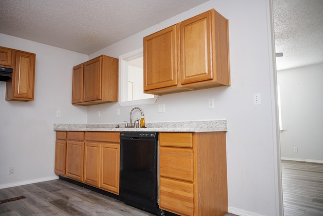 908 Jefferson Ave, Joplin, MO 64801 - kitchen with a textured ceiling, baseboards, black dishwasher, light countertops, and dark wood-style floors