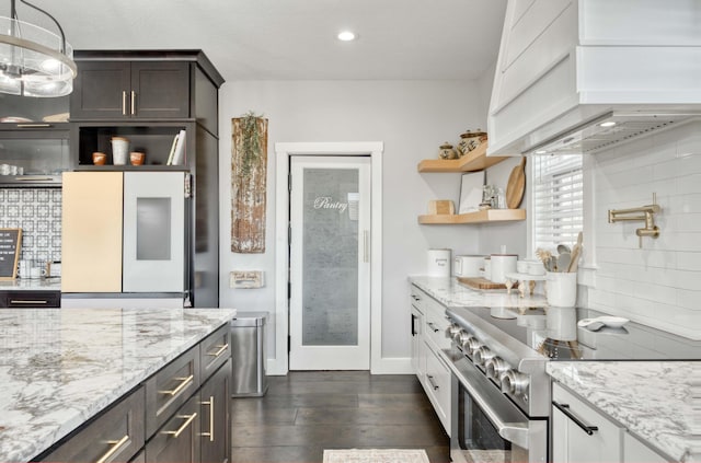 kitchen with dark wood-style floors, refrigerator, high end stainless steel range, premium range hood, and open shelves