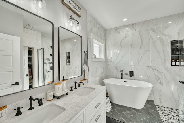 bathroom featuring double vanity, a freestanding tub, a sink, and a marble finish shower