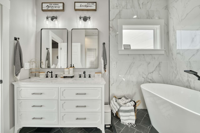 bathroom with double vanity, a soaking tub, and a sink