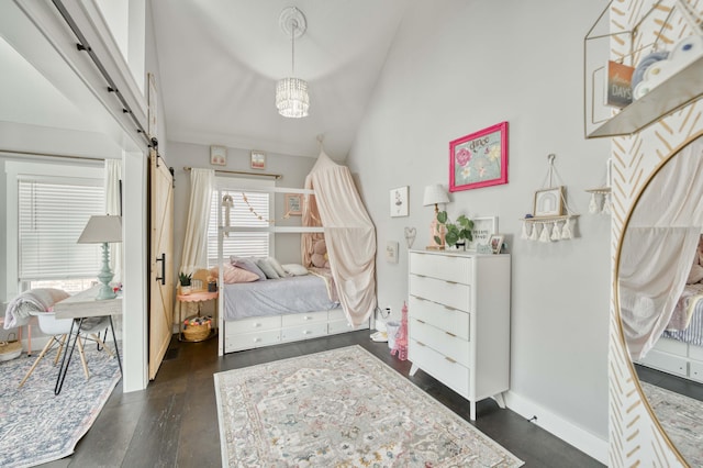 bedroom with high vaulted ceiling, a barn door, baseboards, dark wood-style floors, and an inviting chandelier