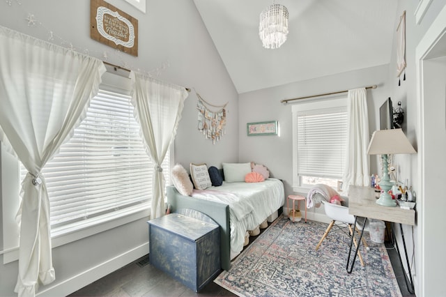 bedroom featuring lofted ceiling, a chandelier, and baseboards