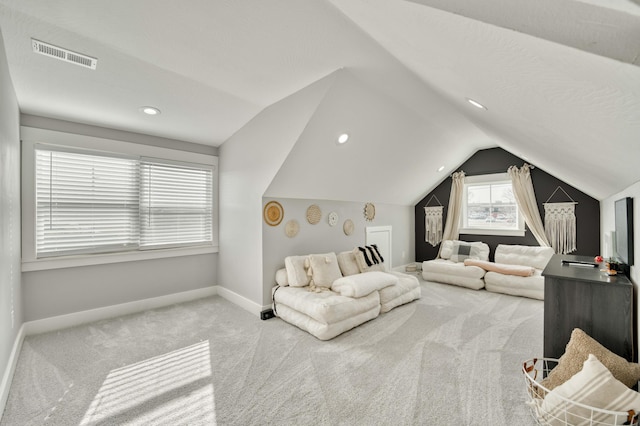 bedroom with carpet floors, lofted ceiling, visible vents, and baseboards