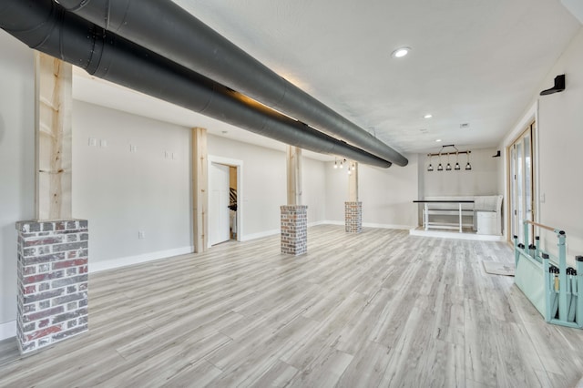 basement featuring recessed lighting, baseboards, and wood finished floors