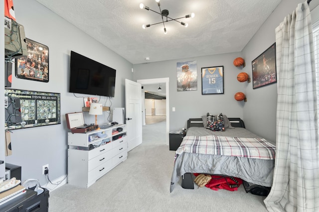 bedroom with a textured ceiling and light colored carpet