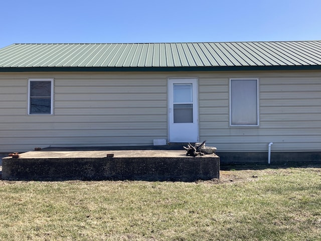 back of house with a yard and metal roof