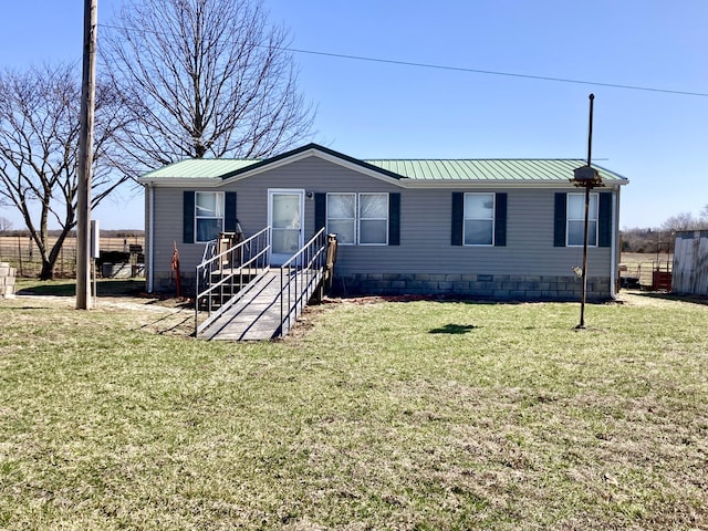 manufactured / mobile home with a front yard, metal roof, and a standing seam roof